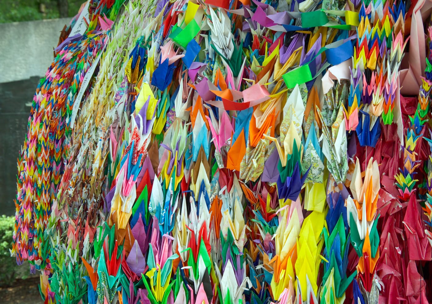 Strings of colorful origami paper cranes (senbazuru) hanging at Peace Memorial Park in Hiroshima, Japan.