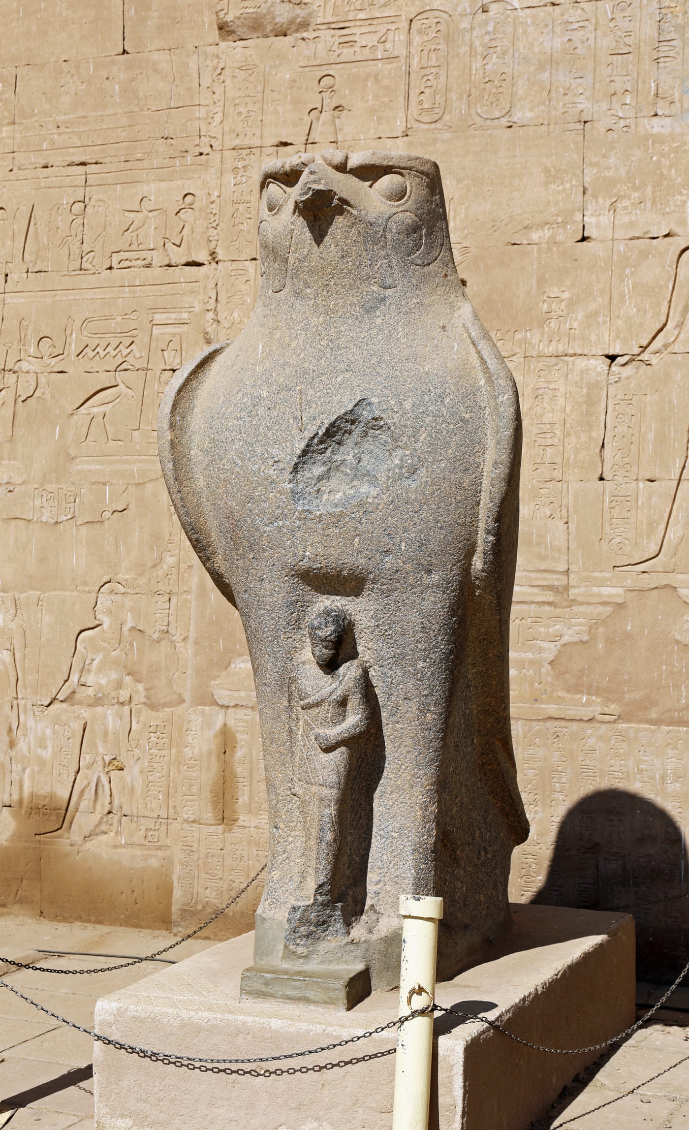 Large granite statue of a falcon representing Horus at the entrance to the Temple of Edfu in Upper Egypt.