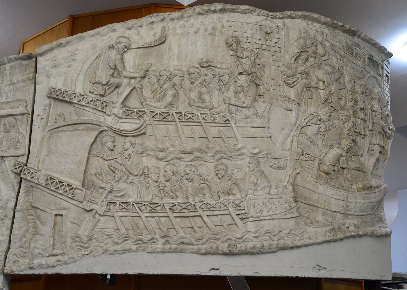 Detail from Trajan's Column, Rome, 113 CE, showing a Roman legionary eagle standard (aquila) being carried into battle, with a depiction of a Roman soldier and eagle bearer.
