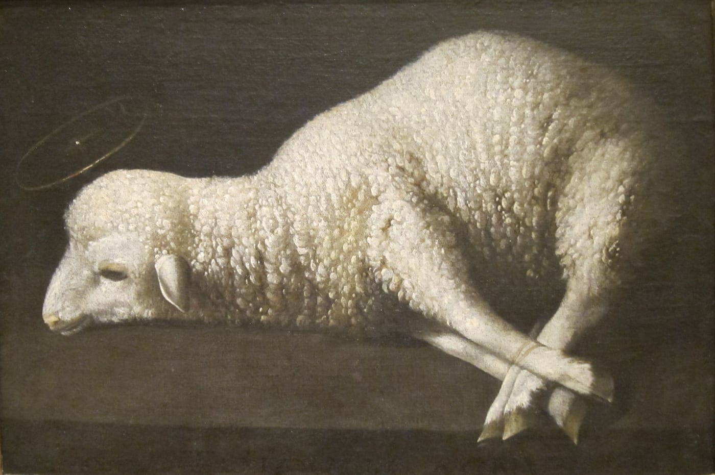 Oil painting by Francisco de Zurbarán of a bound lamb (Agnus Dei) lying on a stone surface, San Diego Museum of Art.
