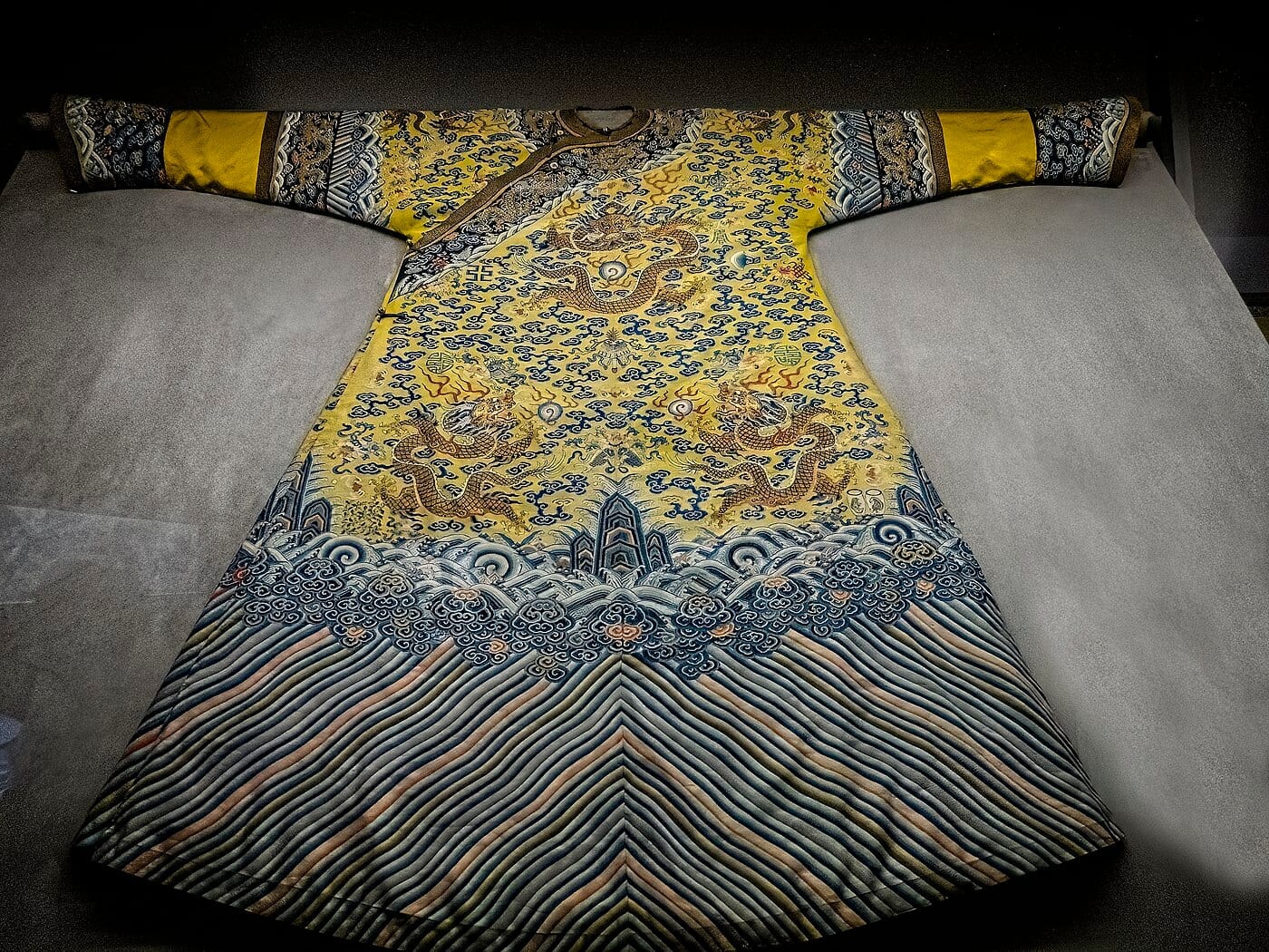 Silk imperial robe from the Qianlong period (1736–1795 CE) of the Qing Dynasty, Beijing, embroidered with multiple five-clawed imperial dragons, Field Museum.