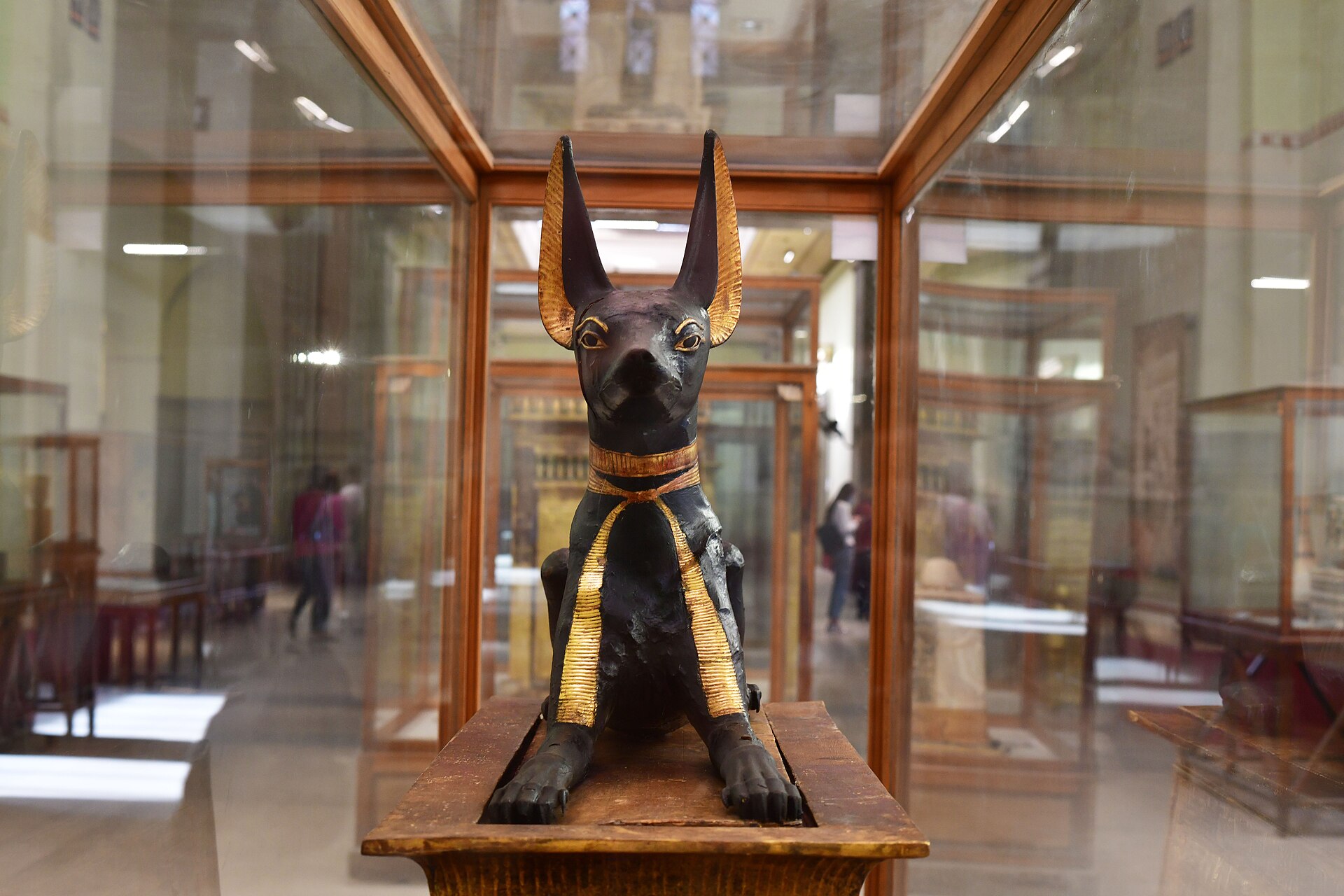 Gilded wooden figure of Anubis as a crouching black jackal, from the Treasury of Tutankhamun's tomb, Dynasty XVIII c. 1323 BCE, Egyptian Museum, Cairo.